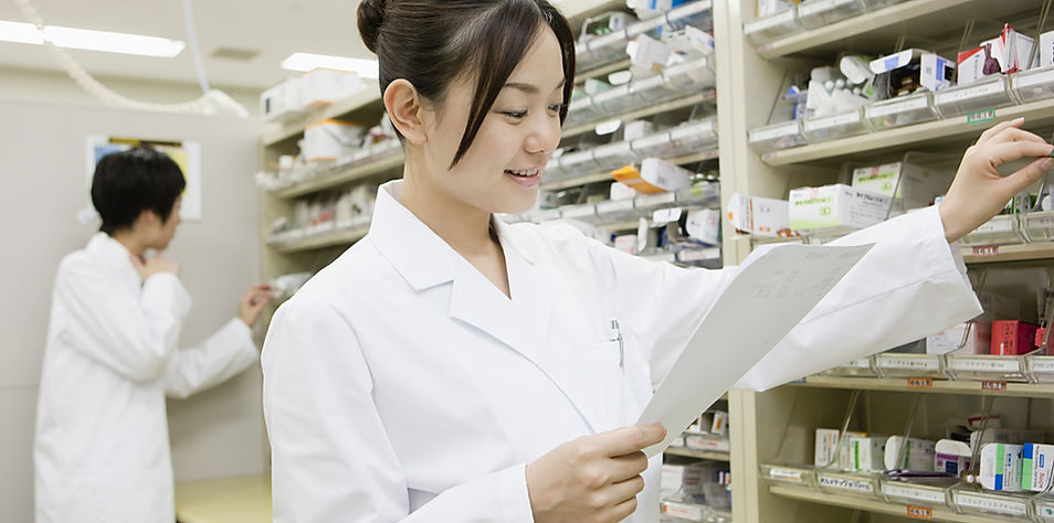 Pharmacist inspecting medicines in pharmacy