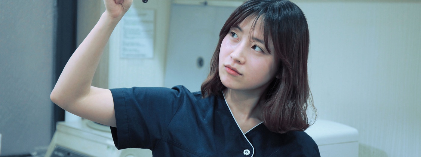 Scientist Looking At Test Tube