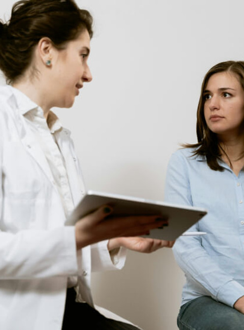 Doctor talking to female patient in clinic