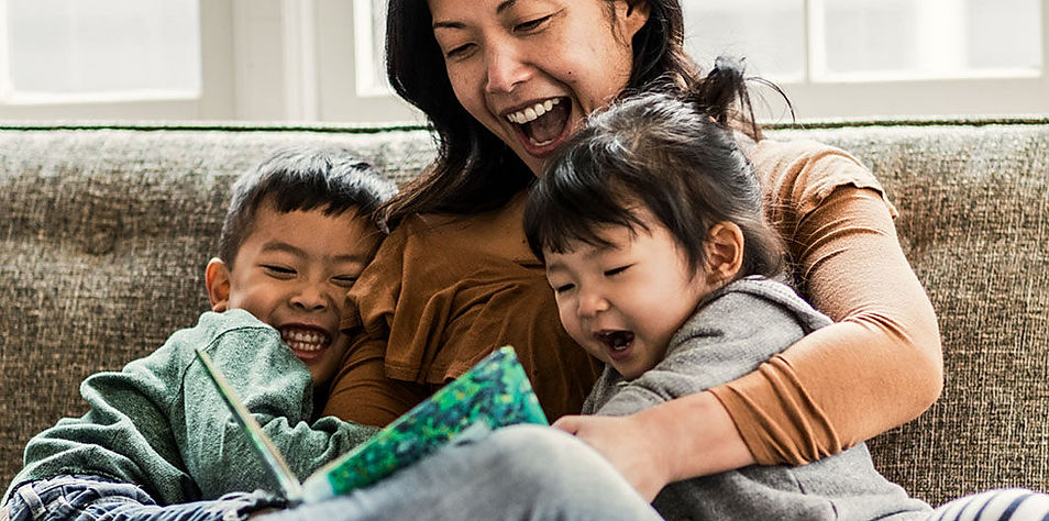 Mother reading book with children